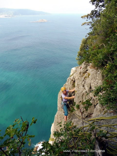 Multipitch climbing above the sea, Spain