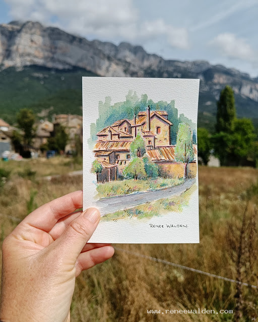 Painting watercolours on top of coloured pencils