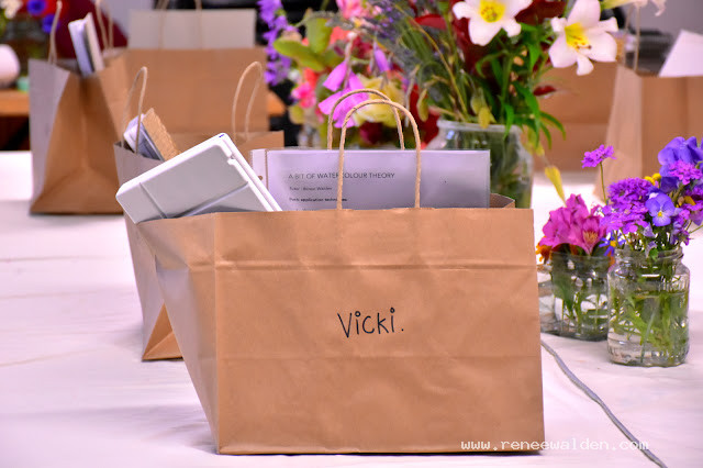 Little packages of arty materials and a room full of flowers