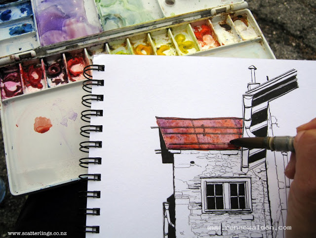 Painting the roof in watercolour and a large brush, wet in wet, 3 or 4 colours